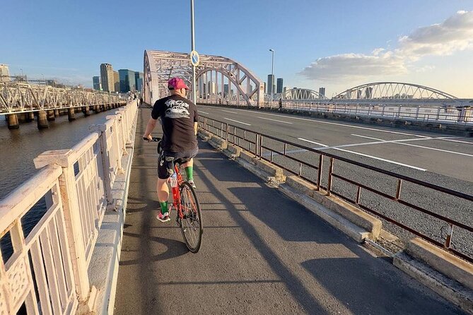 Urban Canvas: Osaka Street Art Bike Tour - Stop 1, Osaka: train lines, rivers, bridges, and the local story behind it